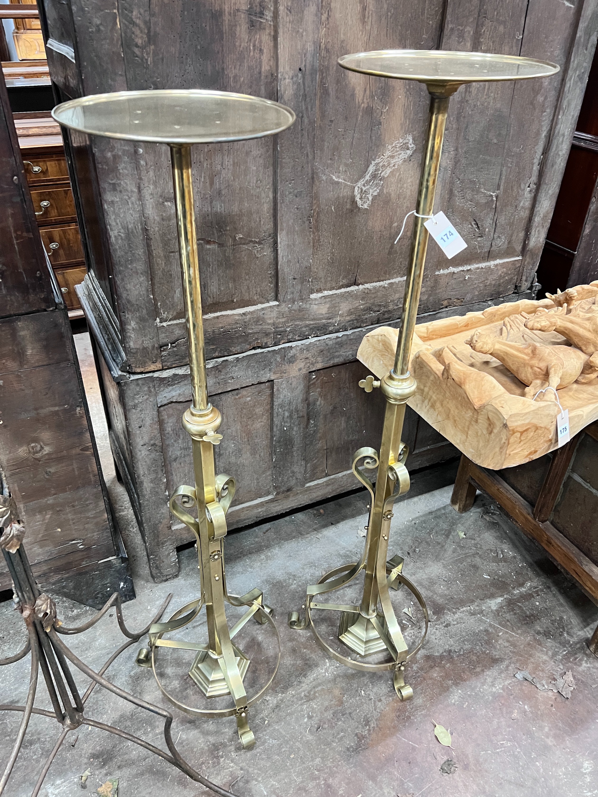 A pair of ecclesiastical brass telescopic candle stands, maximum height 135cm *Please note the sale commences at 9am.